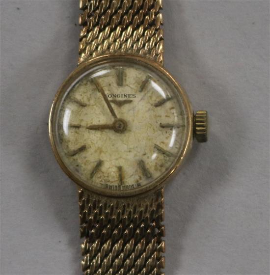 A ladys 9ct gold Longines manual wind wrist watch, on a 9ct gold Longines bracelet,